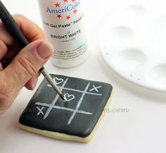 a person is using a marker to write on a chalkboard with an eraser