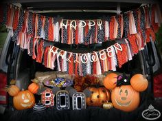 the back of a van decorated for halloween with pumpkins, jack - o'- lanterns and other decorations