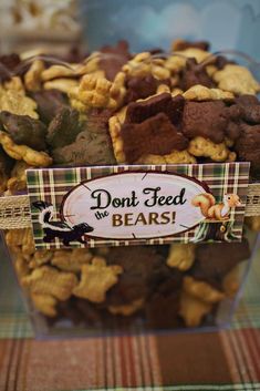 a box filled with lots of different types of dog treats next to a sign that says don't feed the bears