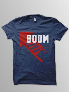 a blue t - shirt with the word boom printed in red and white on it