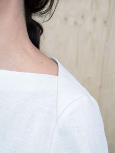 a close up of a person wearing a white shirt