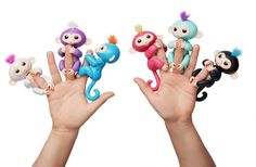 three finger puppets in the shape of monkeys and monkey on their fingers, each with different colors