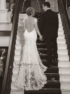 a bride and groom are walking down the stairs at their wedding reception in black and white