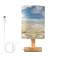 a lamp that is sitting on top of a wooden stand next to a charger