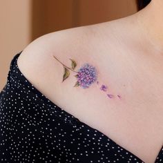 a woman with a flower tattoo on her shoulder