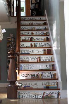 there is a stair case with many books on it