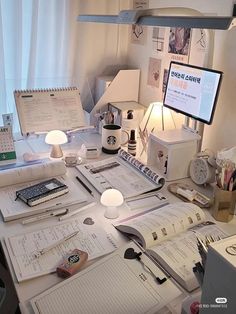 an office desk with many papers on it