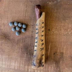 a wooden stick with some blue candies next to it on top of a table