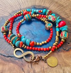 ♥️ Free Shipping ♥️ triple wrap bracelet made from tibetan brass beads ,coral, turquoise and bronze colored beads., with a bronze colored infinity shape bead. It is 22 inches long and can be worn as a necklace as well. Goes round the wrist three times and is suitable for wrist size 6.25-6.75 inches.  Beads:  Tibetan beads and coral nugget beads are approx 7mm / 0.28 inch wide, red beads are 3mm / 0.12 inch wide. Fastens with bronze colored lobster clasp,  Please contact me if you have any questi Turquoise Wrap Bracelet Gift, Turquoise Wrap Bracelet Great For Gifts, Turquoise Multi-strand Wrap Bracelet As Gift, Bohemian Turquoise Wrap Bracelet With Gemstone Beads, Bohemian Turquoise Gemstone Beads Wrap Bracelet, Turquoise Bohemian Wrap Bracelet, Festival Gemstone Beads Wrap Bracelet, Bohemian Bead Bracelet For Meditation, Artisan Turquoise Wrap Bracelet For Festivals