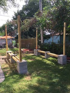 some concrete benches sitting in the middle of a yard