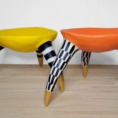 two wooden stools sitting next to each other on top of a hard wood floor