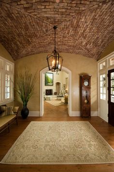 an archway leading to a living room with a clock on the wall next to it