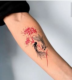 a woman's arm with a red and black koi fish tattoo on it