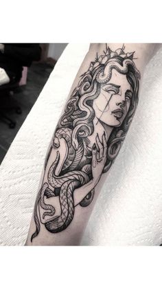 a woman's arm with a tattoo design on it