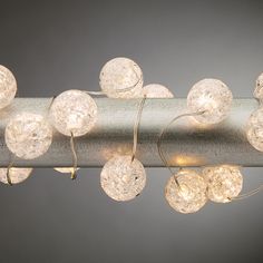 a close up of a light fixture with balls on it