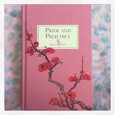 a pink book with red flowers on it