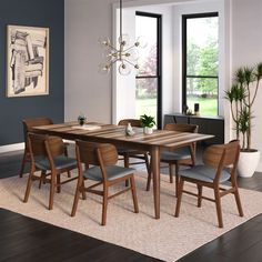 a dining room table with chairs and a potted plant in the corner next to it