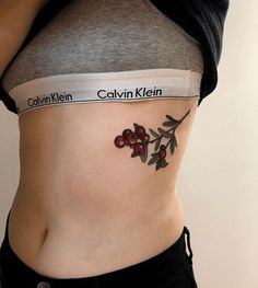 a woman's stomach with tattoos on it and the words cavvin klein