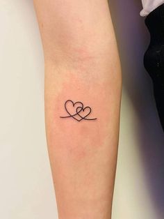 a couple of hearts tattoo on the arm