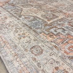 an old rug with faded colors on the floor