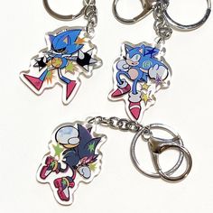 three key chains with cartoon characters on them