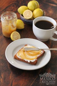 there is a piece of bread on the plate and some lemons in the background