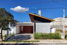 the house is white and has a wooden roof