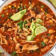 a bowl of chicken tortilla soup with avocado and cilantro