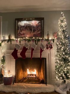 a fireplace decorated for christmas with stockings hanging from the mantel