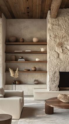 a living room filled with furniture and stone walls