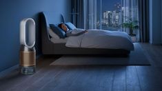 a person laying on a bed in a room with blue walls and floor to ceiling windows