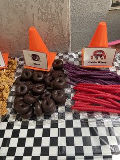 there are many different types of doughnuts on the checkerboard tablecloth