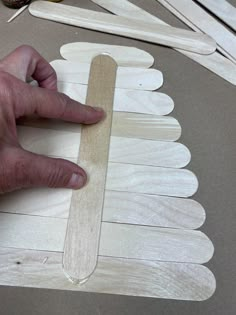 a person making popsicle shapes out of wood