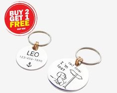 two keychains with the words leo and i am not here printed on them