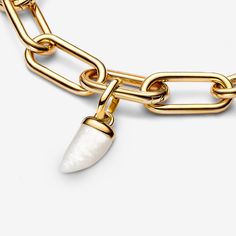 Find your edge when you wear the Pandora ME Shark Tooth Mini Dangle Charm. A white bioresin man-made mother of pearl shaped like a shark tooth is set within a polished 14k gold-plated metal cap and link-shaped bail. A symbol of good luck and protection, stack this shark tooth-inspired charm with other warm-toned styles for a sleek monochromatic look or pair it with sterling silver for an eclectic mixed-metal effect. Can only be styled on openable links. - Pandora ME Shark Tooth Mini Dangle Charm Charms Disney, Pandora Me, Pearl Diamond Jewelry, Pandora Essence, Custom Charm Bracelet, Gold Armband, Solid Gold Necklace, Shark Tooth, Mini Charm