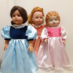 three dolls are standing next to each other