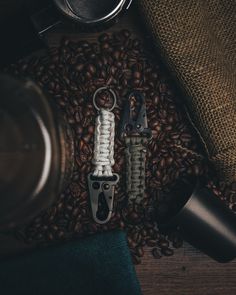 two bottle openers sitting on top of coffee beans