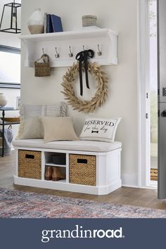 the entryway is decorated with white shelves, baskets and wreaths on top of them