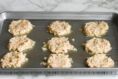 six cookies are on a cookie sheet ready to go in the oven