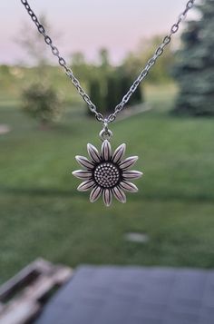 "This necklace has a cute silver sunflower charm.  The charm measures 7/8\" wide.  *Choose your necklace length that check out. The chain is stainless steel.  This will be sent to you in a gift bag or box. This is perfect for anyone! Birthdays, anniversaries, jewelry for bridesmaids, gifts for Mom, or any other occasion. Please contact me if you have any custom requests or questions. Shipping is typically 4 to 6 days in the US, Or you can upgrade to Priority (2 to 3 days) or Express (1 to 2 days). International shipping is between 1 to 3 weeks, depending on your location. You can select an upgrade at checkout." Silver Sunflower Pendant Jewelry, Silver Jewelry With Sunflower Design Flower Pendant, Silver Sunflower Necklace For Mother's Day, Adjustable Silver Charm Necklace With Flower Pendant, Silver Charm Necklace With Flower Pendant, Silver Flower Charm Necklace For Everyday, Adjustable Silver Flower Charm Necklace, Silver Charm Necklace With Flower Charm For Everyday, Adjustable Silver Flower Charm Necklaces