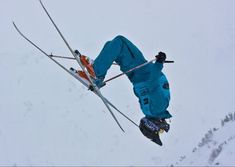 a man flying through the air while riding skis