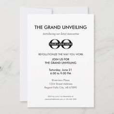 the grand opening announcement card is displayed on a marble surface with white and black lettering