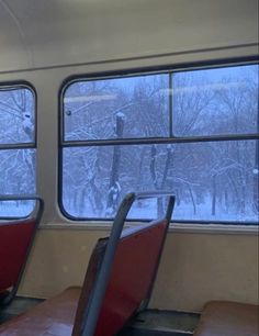 two empty seats on a train in the snow