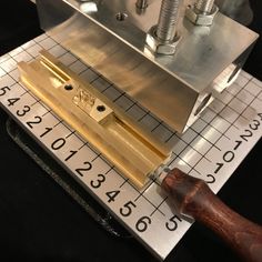 a machine that has some type of tool on it's side and is measuring the width