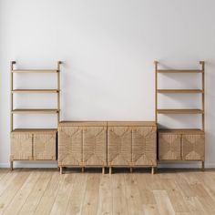 an empty room with two wooden shelves on the wall