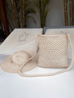 a straw hat and purse sitting on top of a table