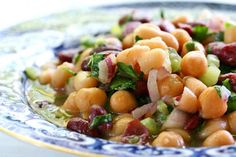 a close up of a plate of food with beans and broccoli