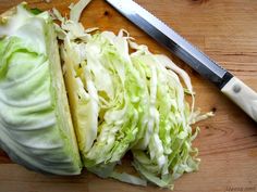 the cabbage is cut up and ready to be sliced into wedges with a knife