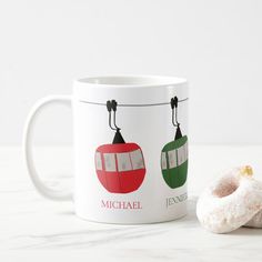 two doughnuts are next to a coffee mug