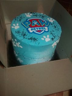 a cake in a box with paw prints on it